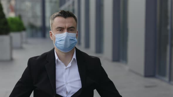 Close Up View of Disabled Male Ceo Executive Wearing Medical Protective Mask and Looking Ahead