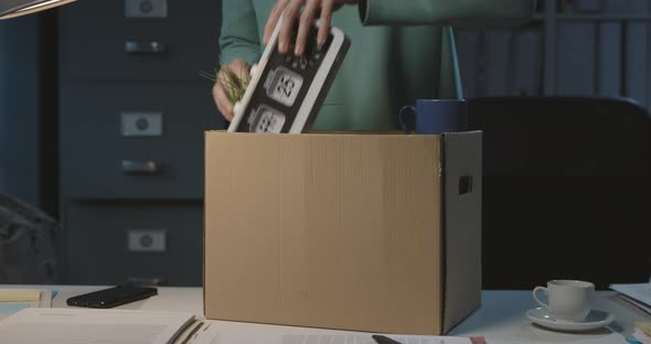 Woman packing her belongings after losing her job