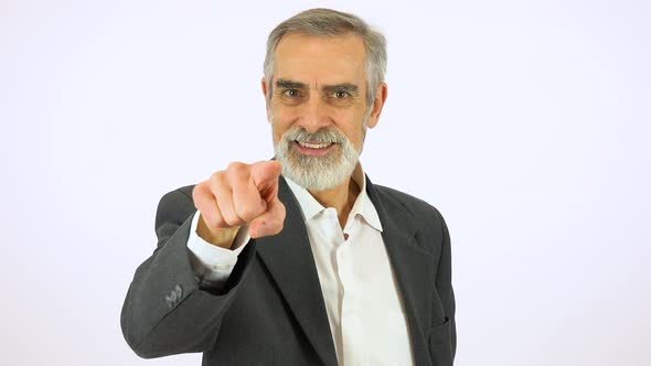 An Elderly Man Points at the Camera and Smiles - White Screen Studio