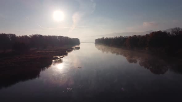 Aerial view of river channels with creeping morning fog.