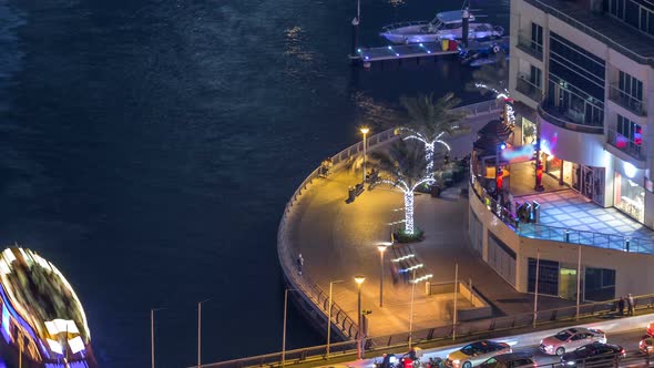 Promenade and Canal in Dubai Marina with Luxury Skyscrapers and Yachts Around Night Timelapse United