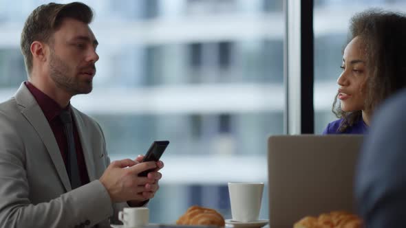 Multiethnic Couple Business People Sitting Using Phone Laptop in Cafe Office