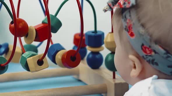 Child Plays with a Multi-colored Toy