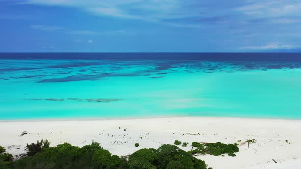 Wide angle drone abstract shot of a paradise sunny white sand beach and aqua turquoise water background