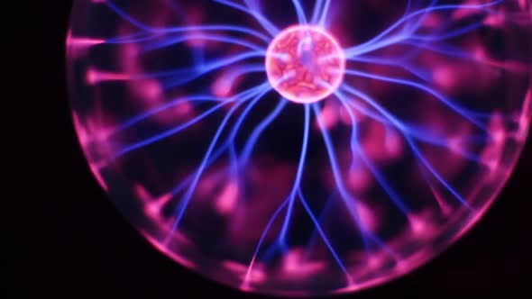 Lightnings Inside a Magic Ball on Black Background. Discharge Lamp. Inert Gas Discharge Tube. Plasma