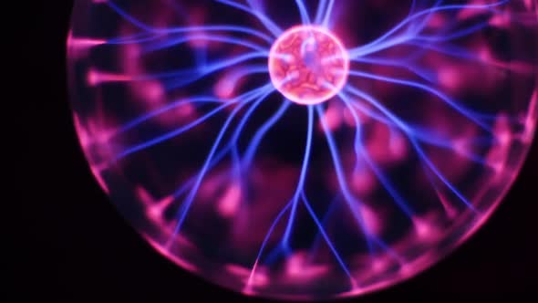 Lightnings Inside a Magic Ball on Black Background. Discharge Lamp. Inert Gas Discharge Tube. Plasma alt
