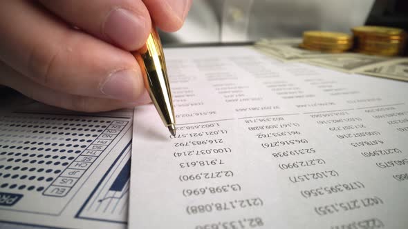 Accountant Analyzing Business Marketing Data on Paper Dashboard at Office Table