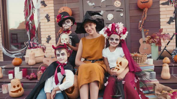 Portrait of Woman and Kids in Halloween Costumes
