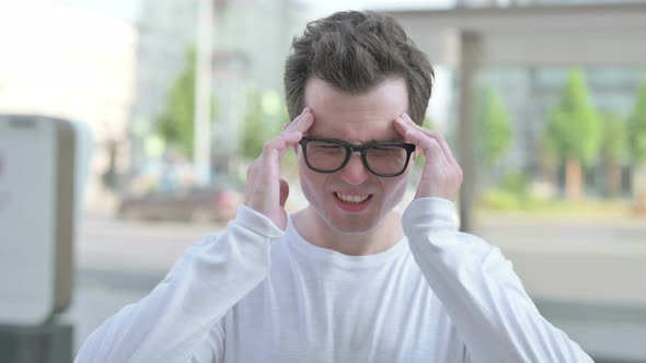 Portrait of Tense Young Man with Headache Outdoor