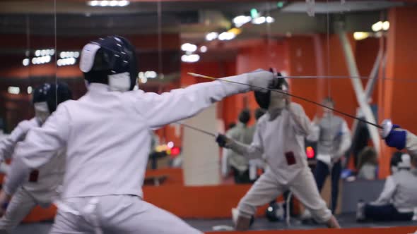 Kids practicing fencing at a fencing school 