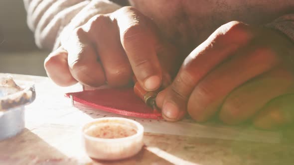 Close up view of man working by hand in factory