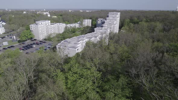 Aerial of apartment buildings in old soviet style surrounded by forest