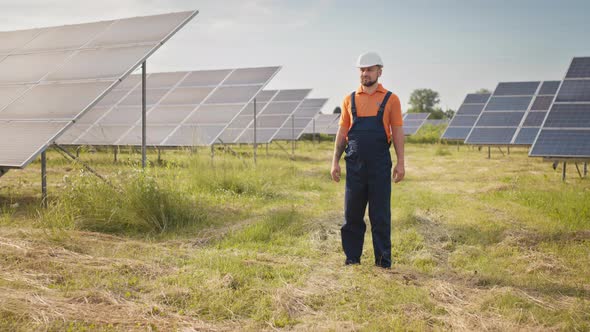 Professional Man Technician in Hard Hat Walks on New Ecological Solar