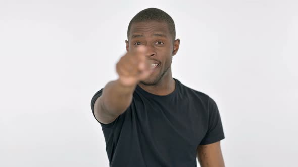 Young African Man Pointing at Camera on White Background