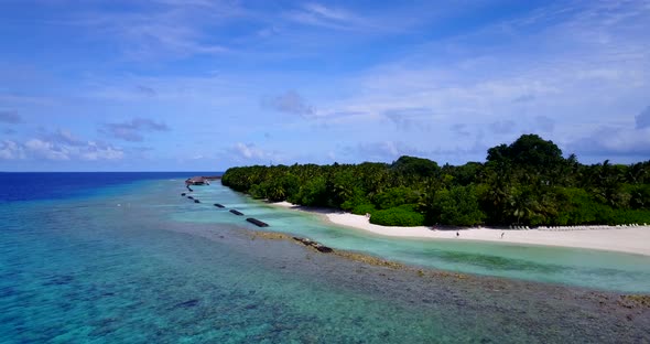 Wide flying abstract view of a sunshine white sandy paradise beach and blue sea background in vibran