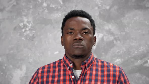 Adult African American Man Looking Camera Standing on Background Gray Wall