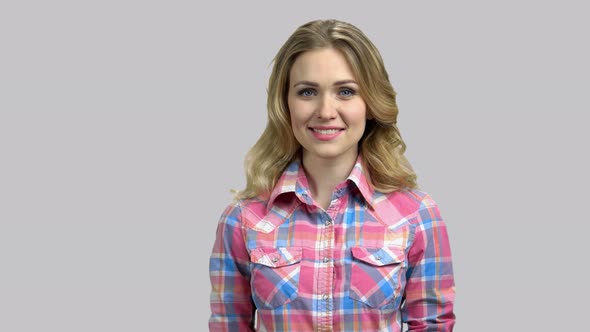 Portrait of a Young Blond Girl Cheerfully Smiling with Teeth