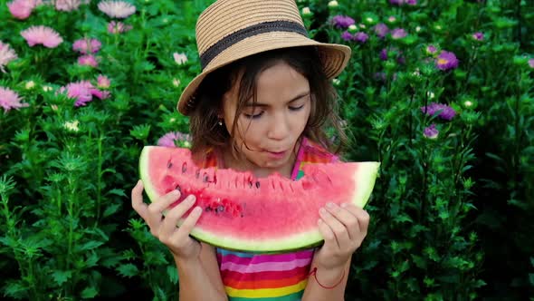 Child Girl Eats Watermelon in Summer