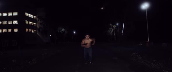 Muscular Man running in the Dark