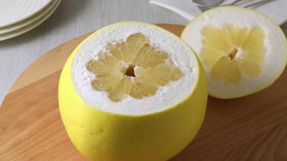 Fresh large yellow pomelo with a cut from the top 