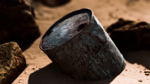 Rusty Metal Oil Barrel on Sand Beach