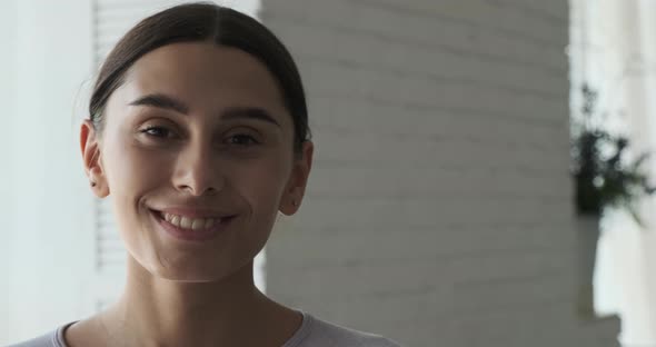 A Young Female Freelancer Designer Looks Confidently Into the Camera and Smiles