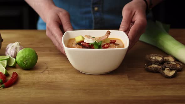 Video of chef decorating the dish with shrimp and serving.