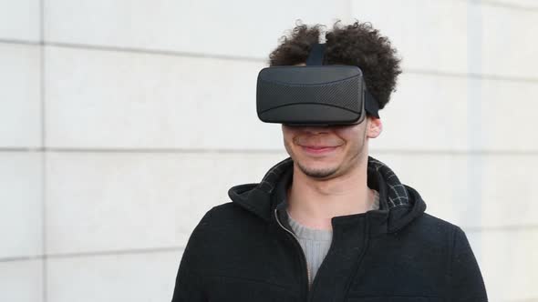 Young mixed race man using 3D viewer