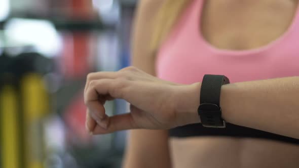 Female Setting up Smart Watch Before Working out In Gym, Active Lifestyle