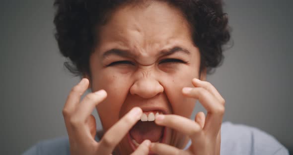 Close Up Portrait of Screaming Emotional Angry Young Woman Isolated on Gray Background