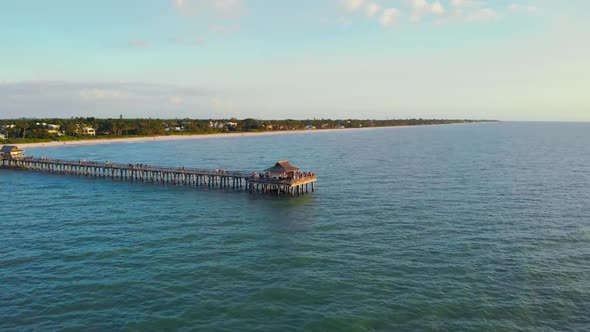 Drone Flies Forward Low Above the Water at Sunset.