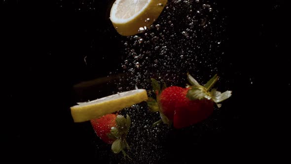 Falling Berries Into Water on a Black Background