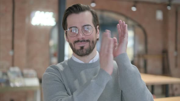 Portrait of Happy Young Man Clapping Applauding