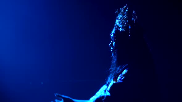 A Dark Silhouette of a Chinese Princess in a Chic Headdress. The Woman Is Performing the Dance of