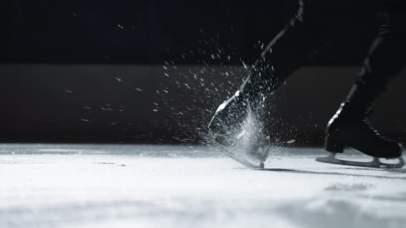 Closeup Shot of a Man Performs a Jump Backwards on Skates