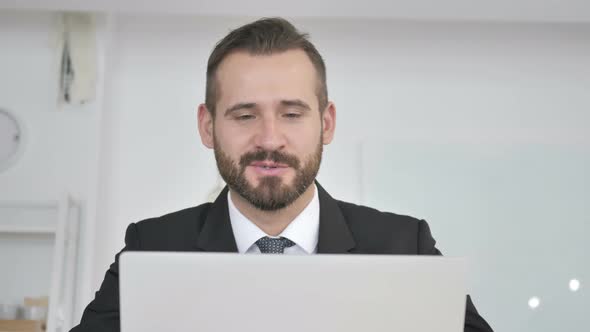 Businessman Talking During Online Video Chat at Work