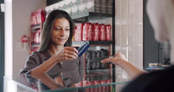 the Beautiful Young Lady Pays with the Card in the Cafe Contactless Payment