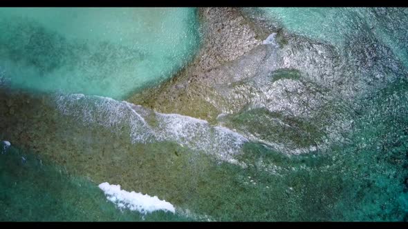 Aerial drone shot nature of exotic shore beach trip by blue lagoon with white sandy background of a 