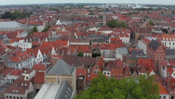 Cityscape Over Bruges, Belgium with Red Rooftops with Churches From Aerial Perspective