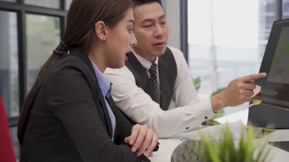 Asian young business man and woman people use computer and having a discussion meeting in office.