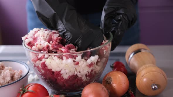 Kneading of Minced Meat with Onion and Spices in a Glass Bowl