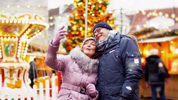 Senior Couple Taking Selfie at Christmas Market