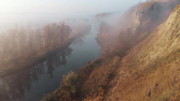 Aerial Drone View of Sunrise Over Misty River