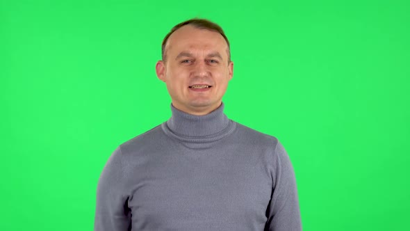 Portrait of Male Waving Hand and Showing Gesture Come Here. Green Screen
