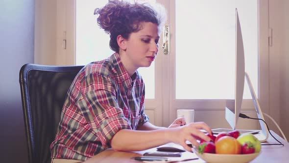 Young woman working at home or in a small office