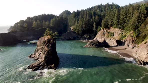 Drone flying over sea stacks on beautiful Secret Beach on the Oregon Coast.