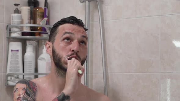 Close Up of Bearded Caucasian Man Brushing Teeth and Taking Shower