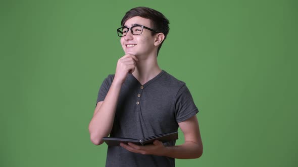 Young Handsome Iranian Teenage Boy Against Green Background