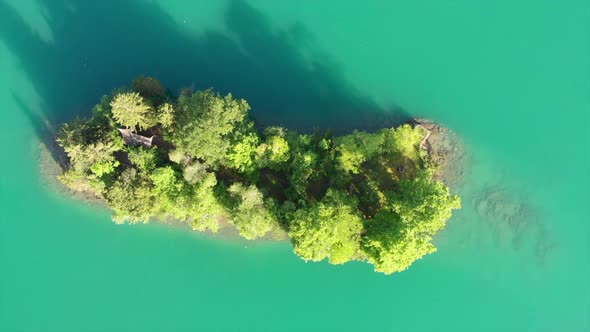 Birdview of little island in a lake in Iseltwald, Switzerland called Schnaeggeinseli. Early morning