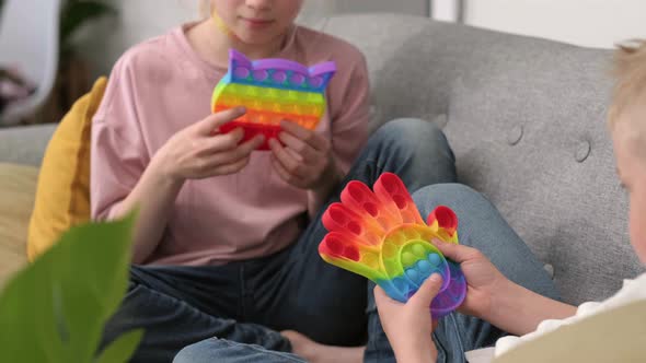 Kids Playing with Pop It Sensory Toy